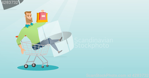Image of Young caucasian man riding in shopping trolley.