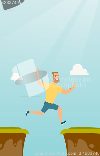 Image of Young caucasian sportsman jumping over the cliff.