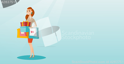 Image of Woman holding shopping bags and gift boxes.