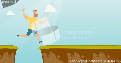 Image of Young caucasian sportsman jumping over the cliff.