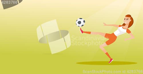 Image of Young caucasian soccer player kicking a ball.