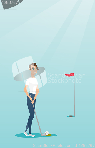 Image of Young caucasian golfer hitting a ball.