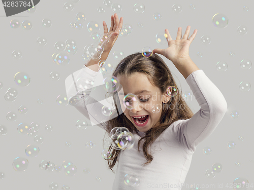 Image of Girl playing with soap bubbles
