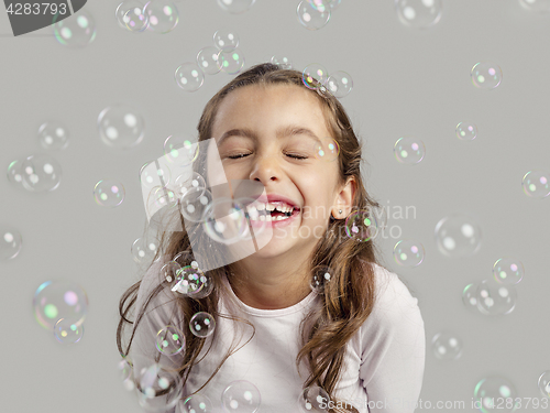 Image of Girl playing with soap bubbles