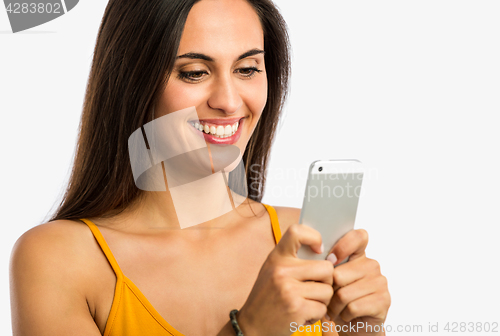 Image of Happy woman texting