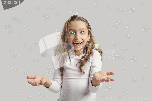 Image of Girl playing with soap bubbles