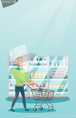 Image of Young caucasian man with supermarket trolley.