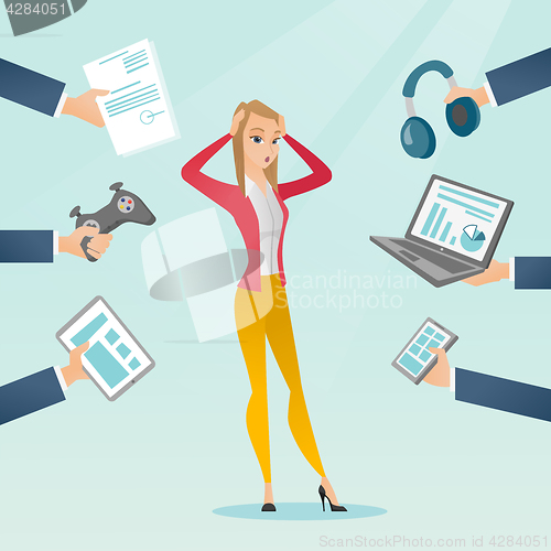 Image of Young caucasian woman surrounded by her gadgets.