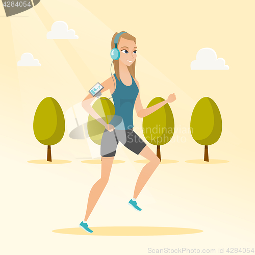 Image of Young woman running with earphones and smartphone.