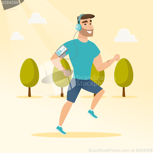 Image of Young man running with earphones and smartphone.