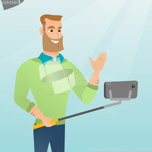 Image of Young caucasian hipster man making selfie.