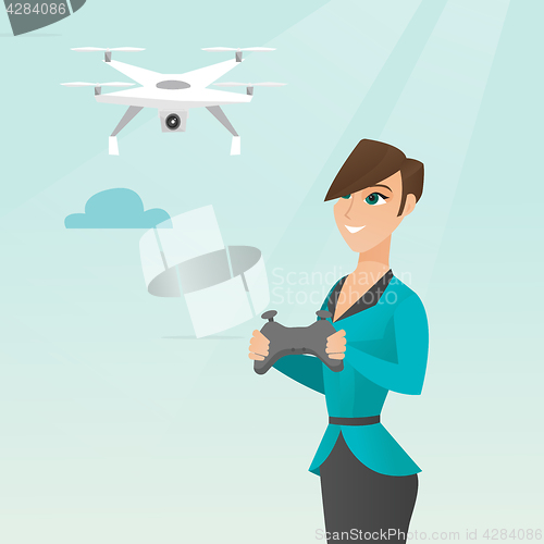 Image of Young caucasian woman flying drone.