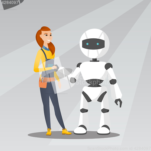 Image of Young caucasian woman handshaking with robot.