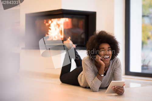 Image of black women using tablet computer on the floor