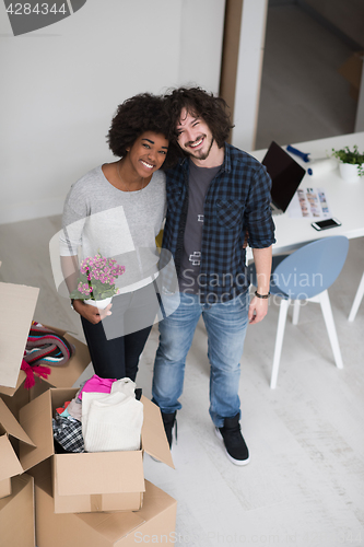 Image of multiethnic couple moving into a new home