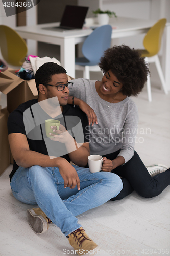 Image of African American couple relaxing in new house