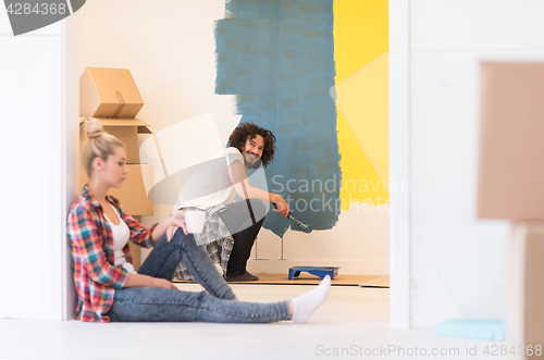 Image of young couple doing home renovations