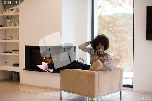 Image of black woman in front of fireplace