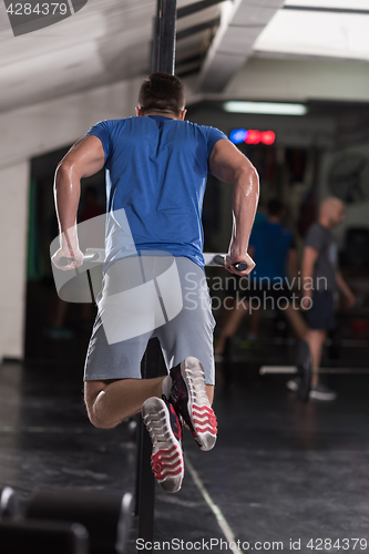 Image of man doing exercises parallel bars