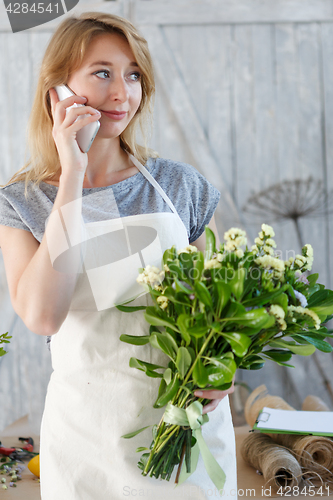 Image of Florist girl talking on phone