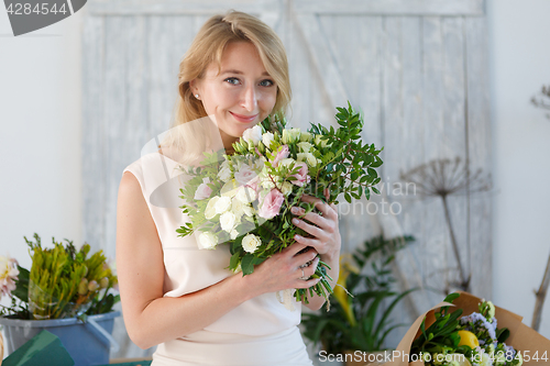 Image of Beautiful blonde in flower shop