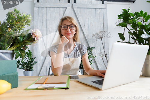 Image of Florist girl sitting at table