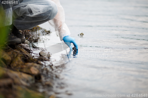 Image of Human takes sample of water