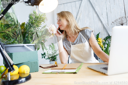 Image of Blond florist talking on phone