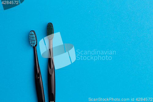 Image of Photo of two black toothbrushes