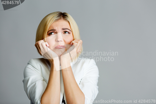 Image of Blonde with hand at chin