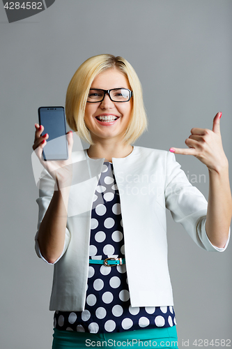 Image of Girl with phone showing gesture