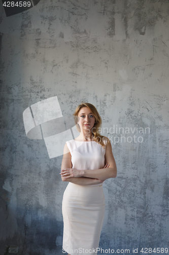 Image of Long-haired beautiful blonde in dress