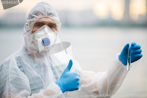 Image of Chemist in respirator with test-tube