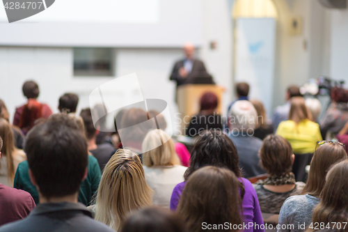 Image of Man giving presentation in lecture hall at university.