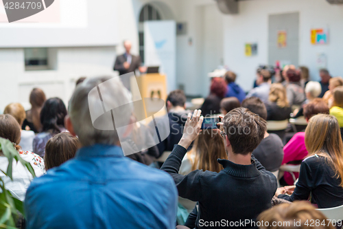 Image of Man giving presentation in lecture hall at university.