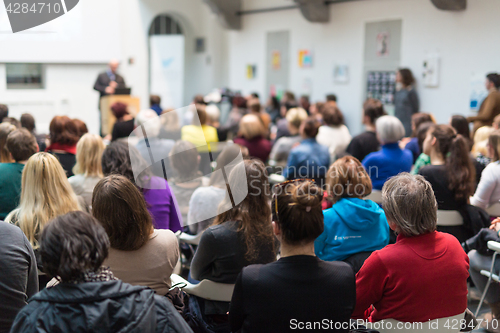 Image of Man giving presentation in lecture hall at university.