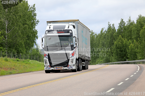 Image of Colorful Volvo FH Cargo Transport along Highway