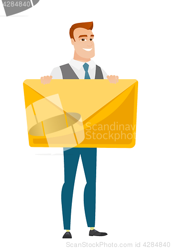 Image of Smiling businessman holding a big envelope.