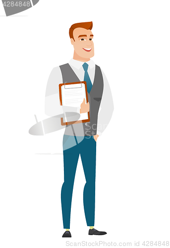 Image of Businessman holding clipboard with papers.