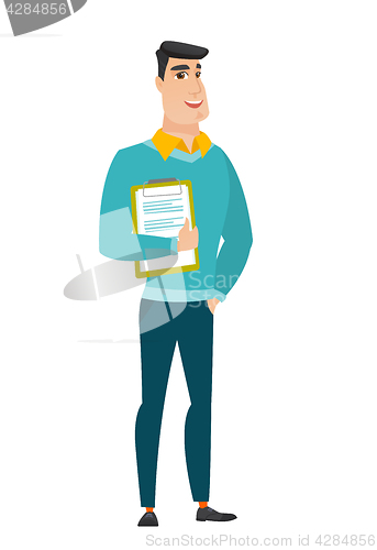 Image of Businessman holding clipboard with papers.