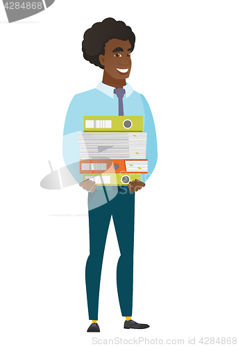 Image of Businessman holding pile of folders.