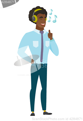 Image of Businessman listening to music in headphones.