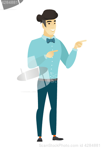 Image of Young asian businessman pointing to the side.