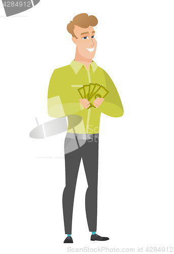 Image of Happy caucasian businessman holding money.