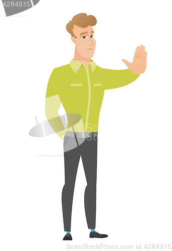 Image of Caucasian businessman showing stop hand gesture.
