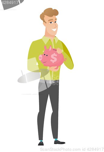 Image of Caucasian business man holding a piggy bank.