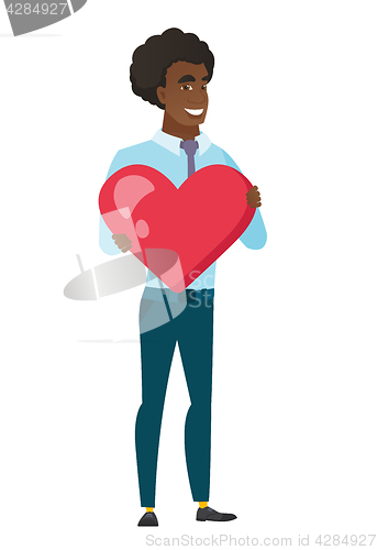 Image of Caucasian business man holding a big red heart.