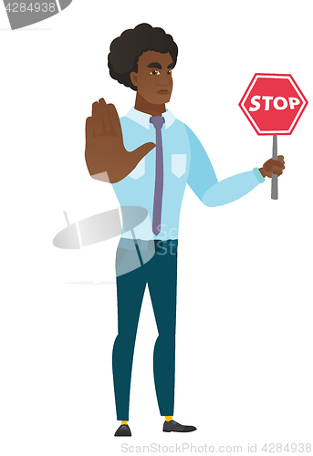 Image of Caucasian businessman holding stop road sign.