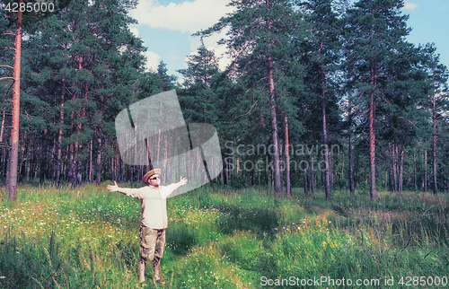 Image of Man Raised Arms in Forest