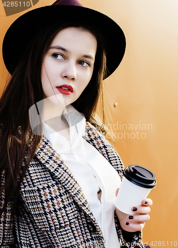 Image of young pretty hipster girl student with coffee cup posing adorable smiling, lifestyle people concept outdoor 
